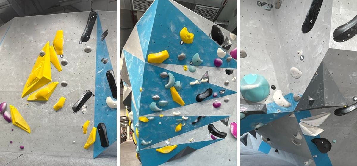 Three bouldering walls at Boulderwelt Hamburg side by side: on the left a grey wall with a line of large yellow holds and volumes, in the middle a steep blue and grey wall, on the right a grey wall with a large turquoise ball and white holds.