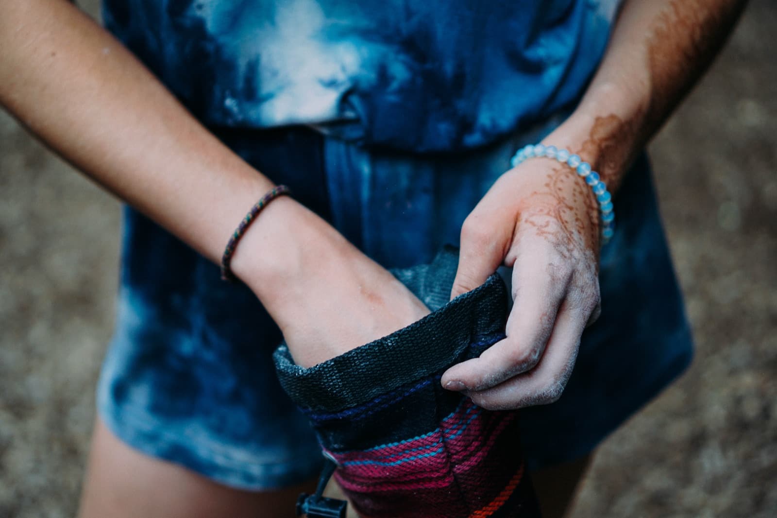 A climbing chalk bag hanging on a wall.