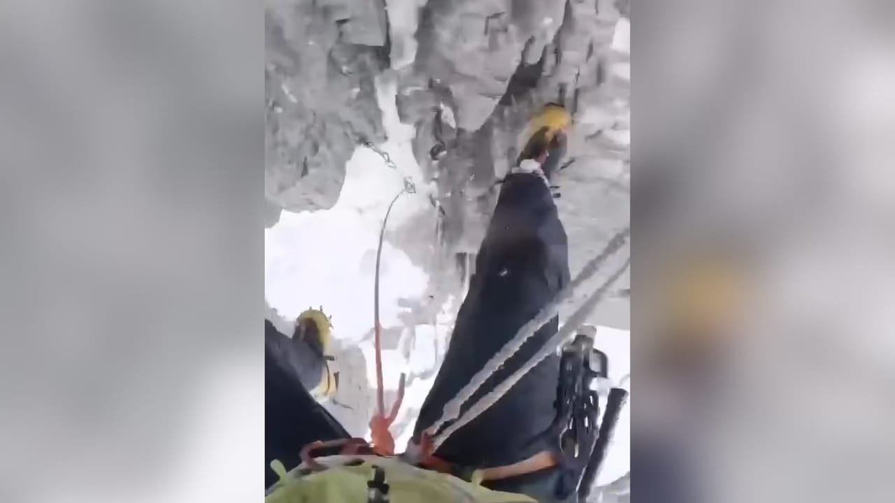 Alpine climbing scene illustrating a safety rule broken