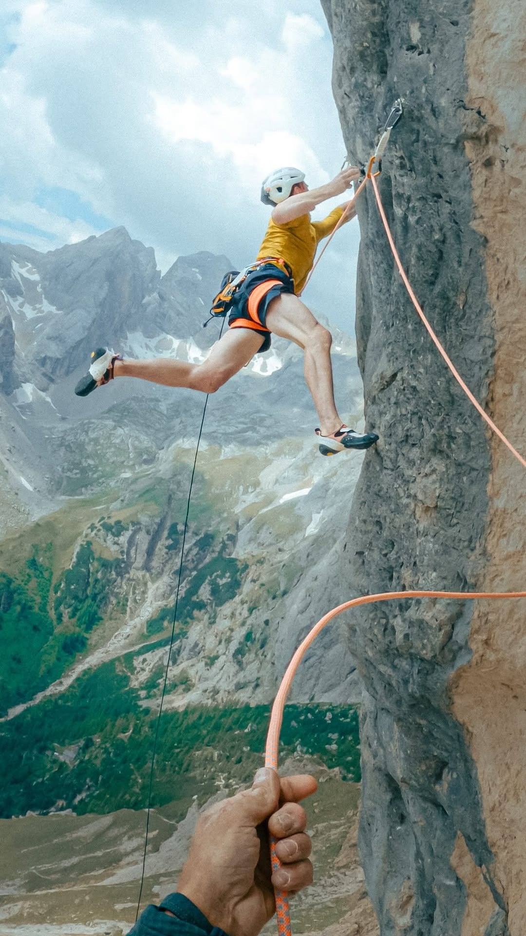 Climber on the grey limestone south face of the Marmolada