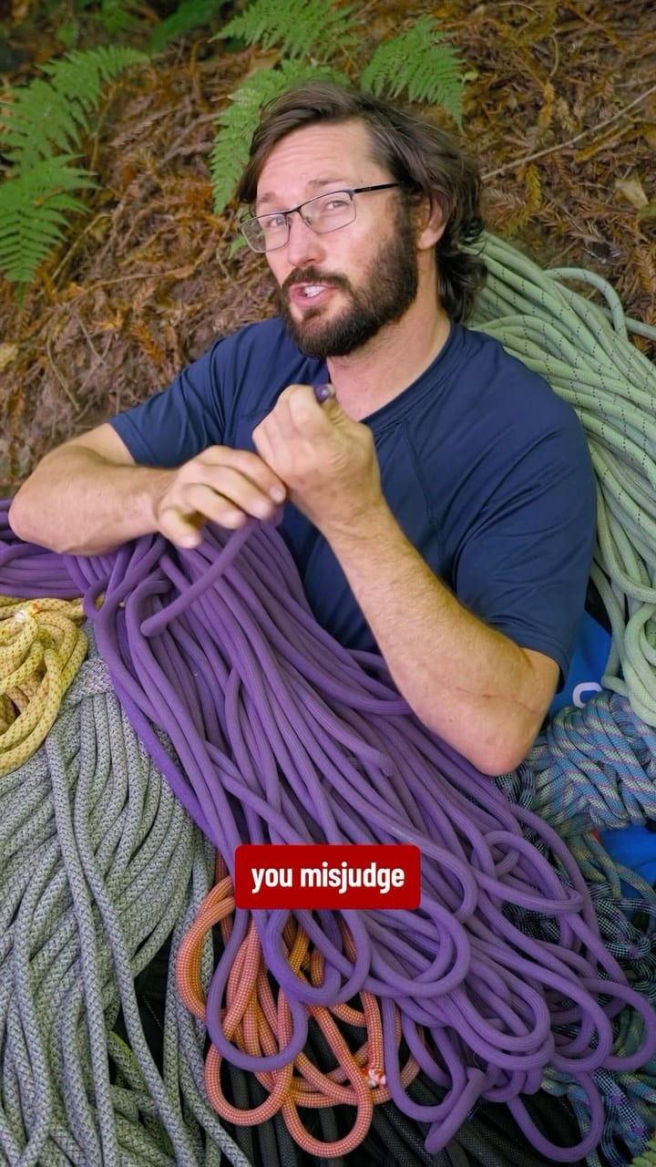 Climbing rope coiled on the ground at the crag
