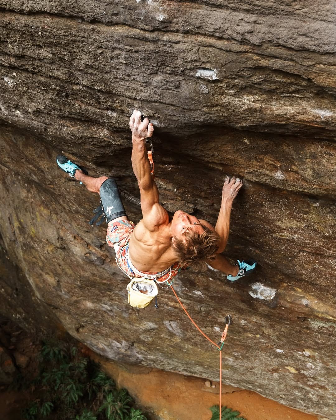 Alexander Megos climbing on orange sandstone in Australia
