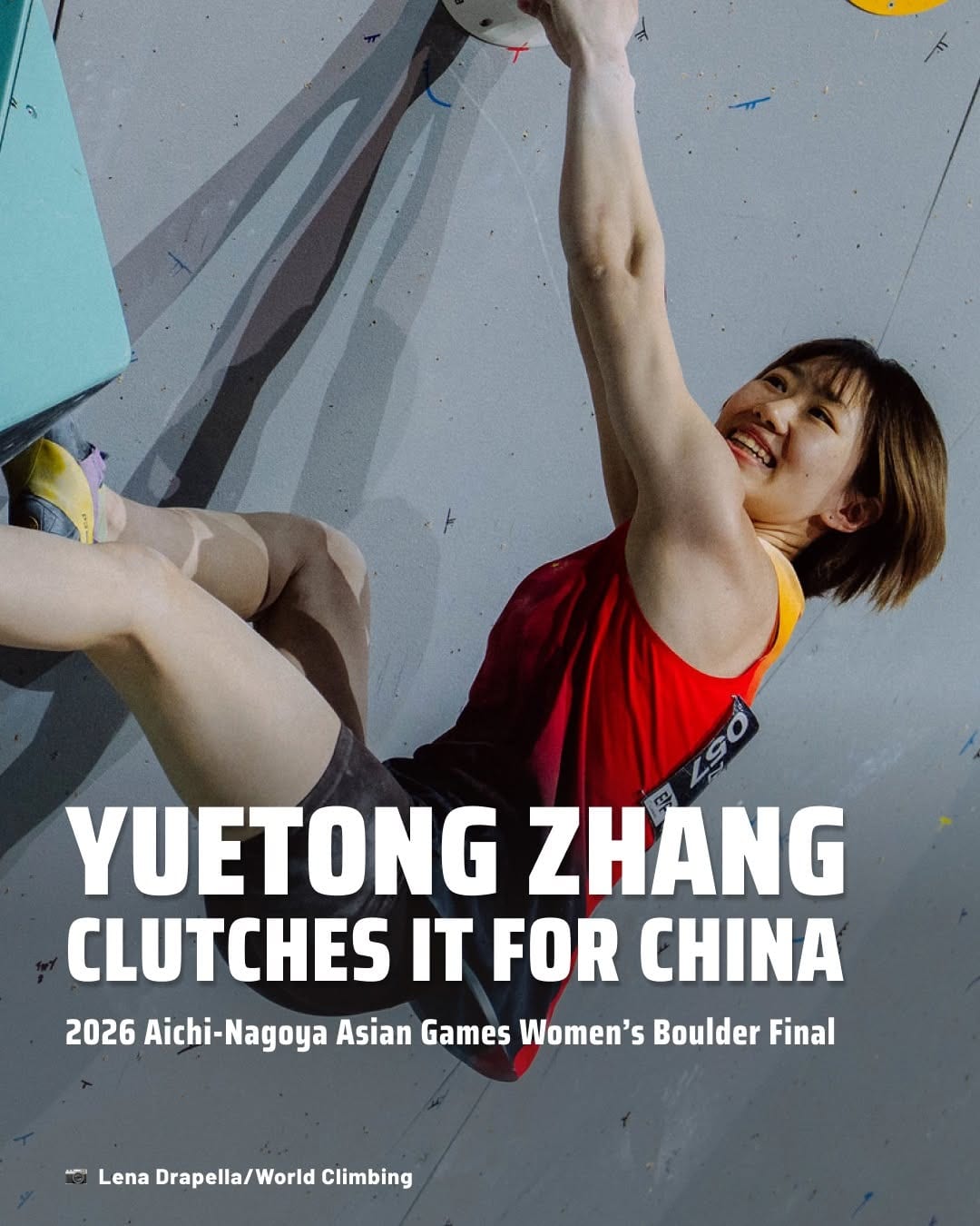 Yuetong Zhang smiling as she reaches for a hold in the Asian Games boulder final