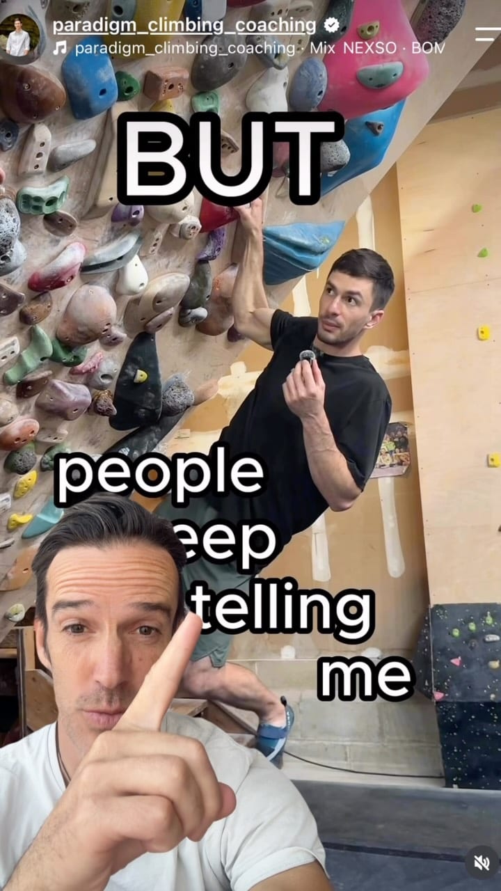 Screenshot of a coaching video in a climbing gym with a coach pointing upwards
