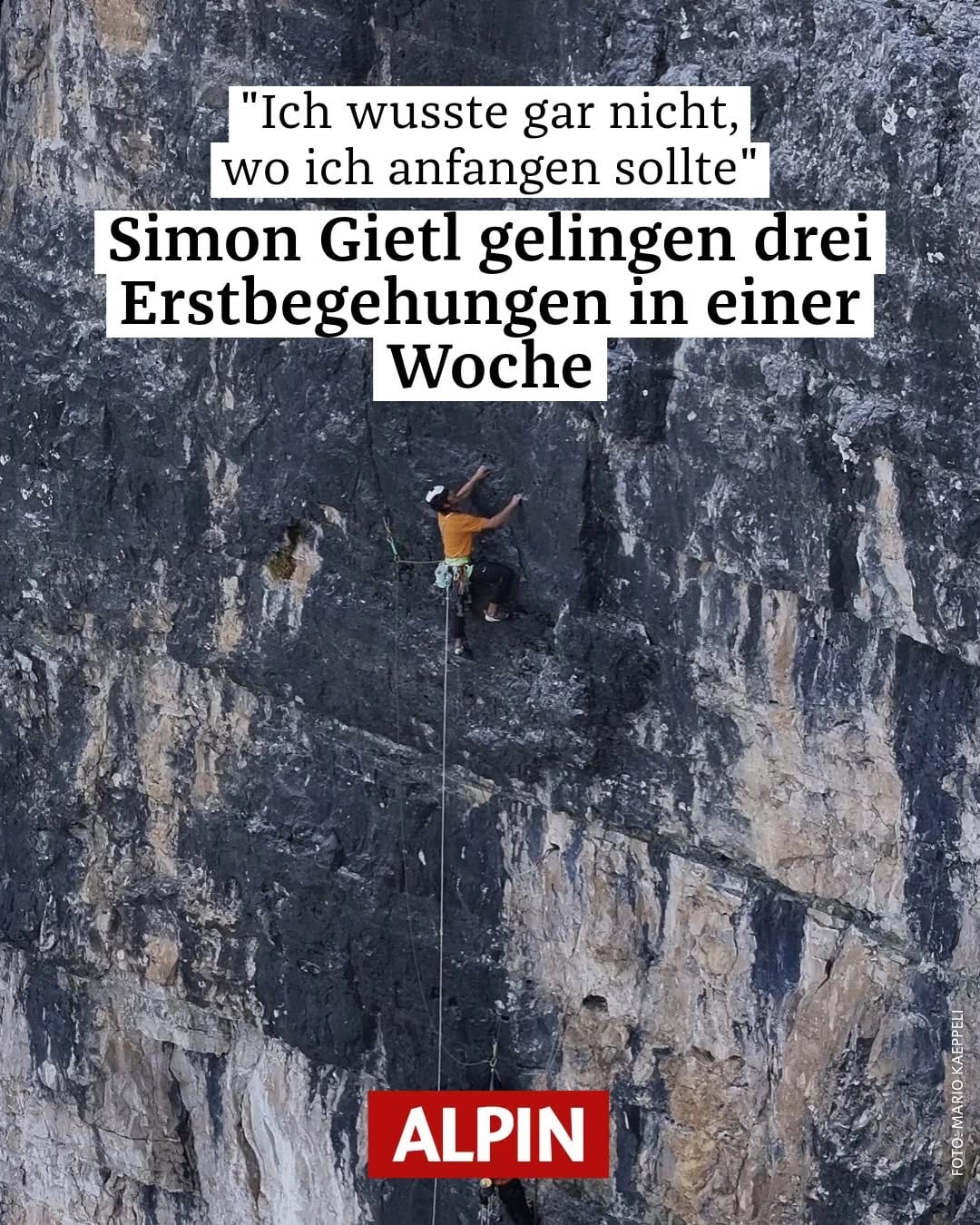 Climber on a vast dark limestone wall under a magazine headline quoting Simon Gietl