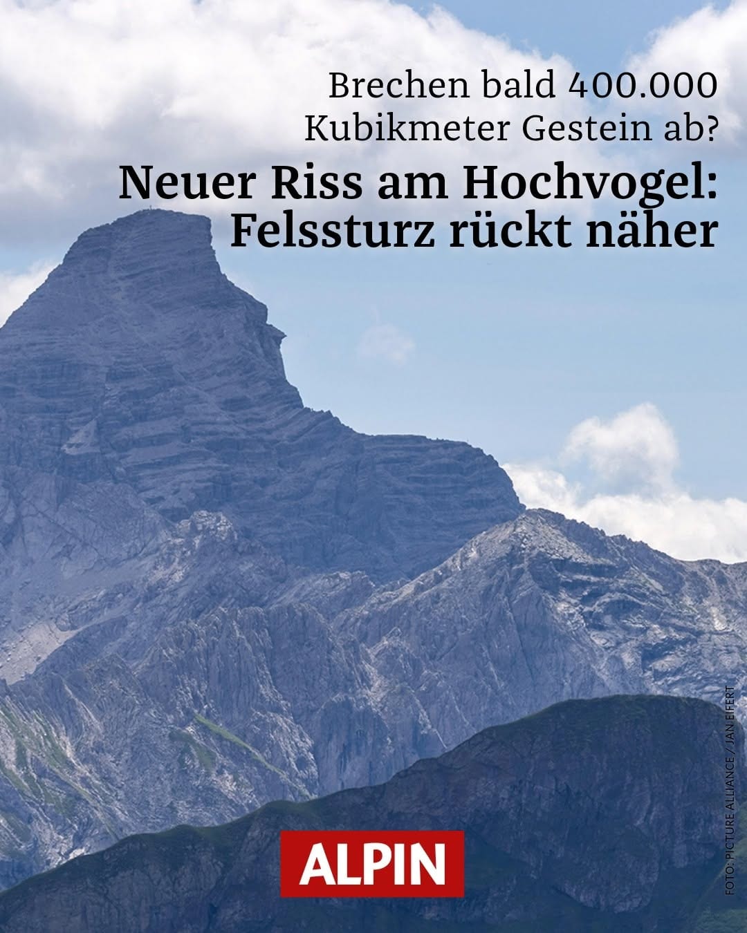 The jagged summit of the Hochvogel under a blue sky with a magazine headline about a new crack